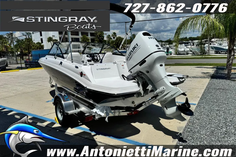 Slide: The Image of 2026 Stingray 191DC Dual Console boat with Suzuki outboard motor on a trailer. - 3