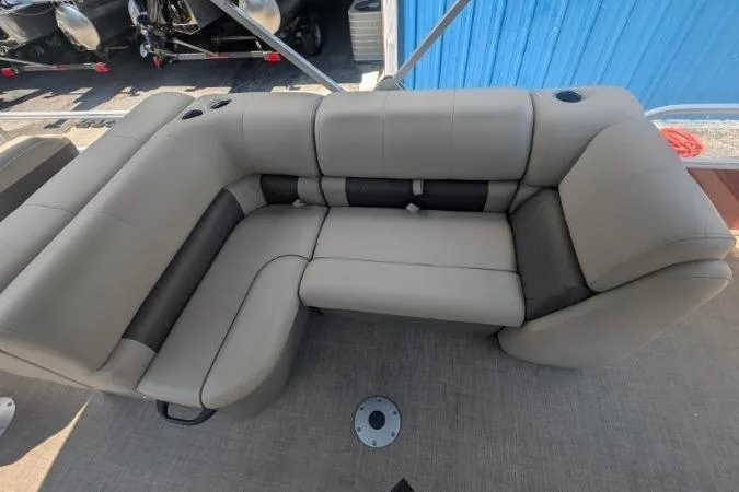 Slide: The Image of 2022 Sun Tracker SportFish 22 DLX boat seating, featuring plush, beige upholstery. - 6