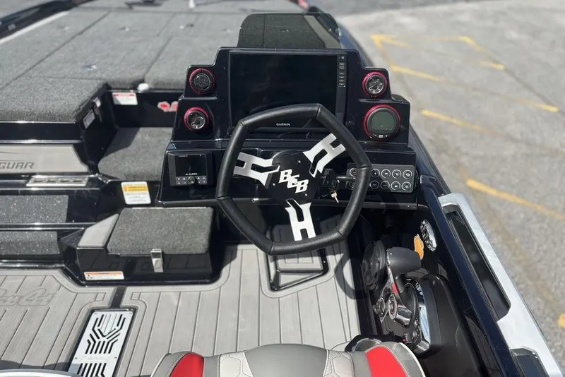 Slide: The Image of Interior of 2026 Bass Cat Jaguar STS boat with steering wheel and dashboard controls. - 10