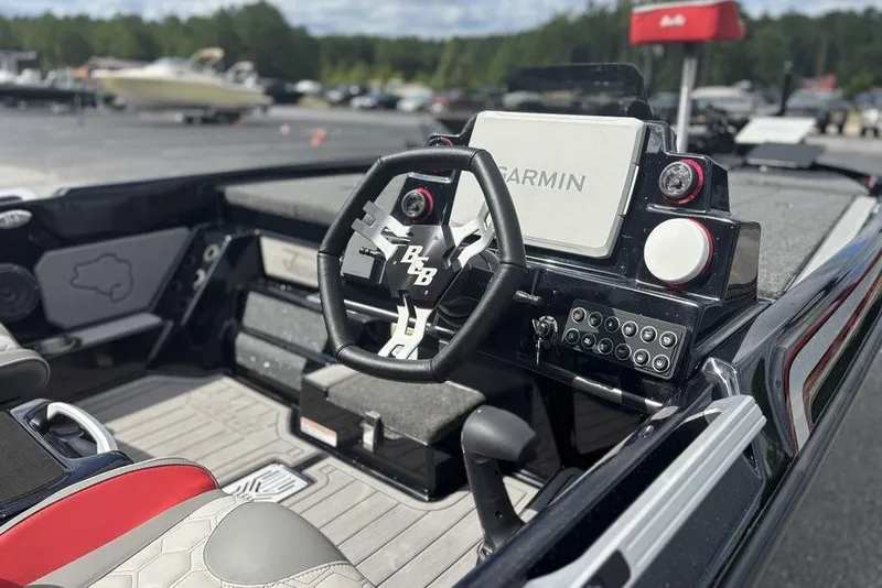 Slide: The Image of 2026 Bass Cat Jaguar STS boat interior with Garmin navigation system and modern steering wheel. - 11