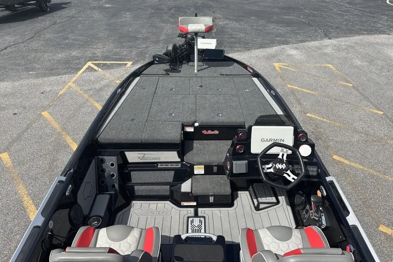 Slide: The Image of 2026 Bass Cat Jaguar STS boat interior with Garmin navigation system and dual seats. - 14