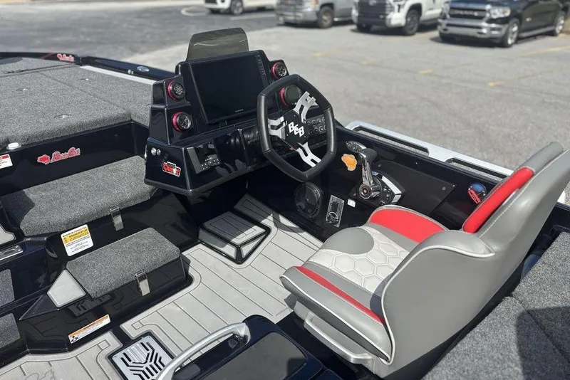 Slide: The Image of 2026 Bass Cat Jaguar STS boat interior with steering wheel, dashboard, and seating. - 4