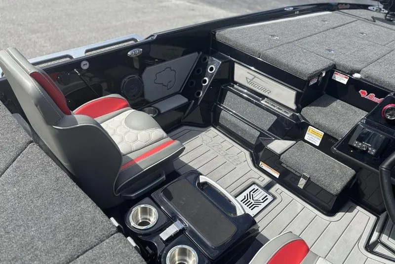 Slide: The Image of 2026 Bass Cat Jaguar STS boat interior with gray and red seating, storage compartments, and modern design. - 9