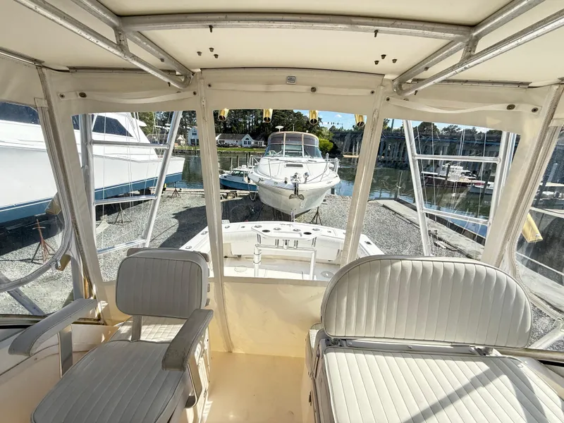 Slide: The Image of 2001 Albemarle 280 Express Sport Fisherman boat interior with white seating, docked at marina. - 13