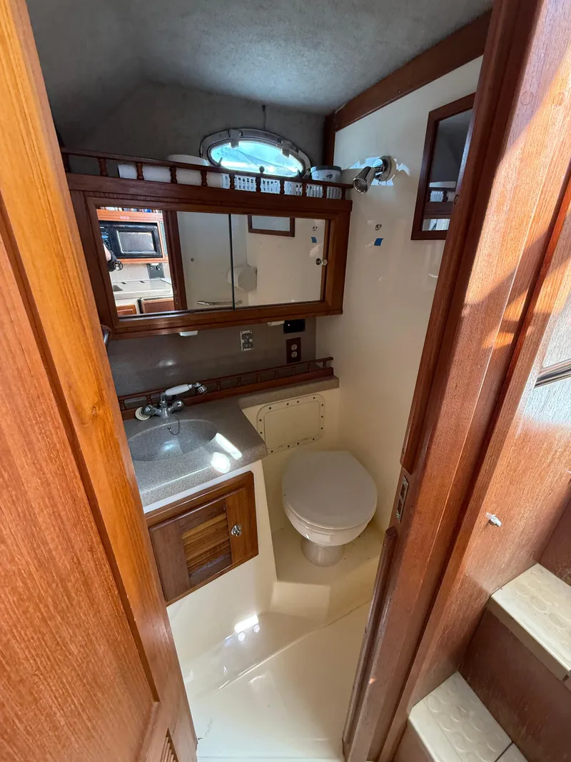 Slide: The Image of 2001 Albemarle 280 Express Sport Fisherman bathroom with wood accents and compact design. - 25