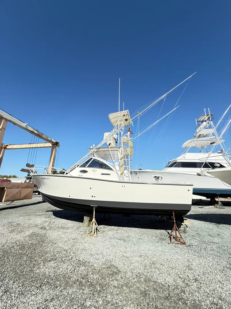 Slide: The Image of 2001 Albemarle 280 Express Sport Fisherman boat on dry dock under clear blue sky. - 48