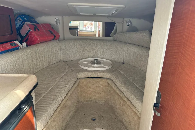 Slide: The Image of Interior cabin of 2005 Sea Ray 290 SLX with cushioned seating and storage. - 15