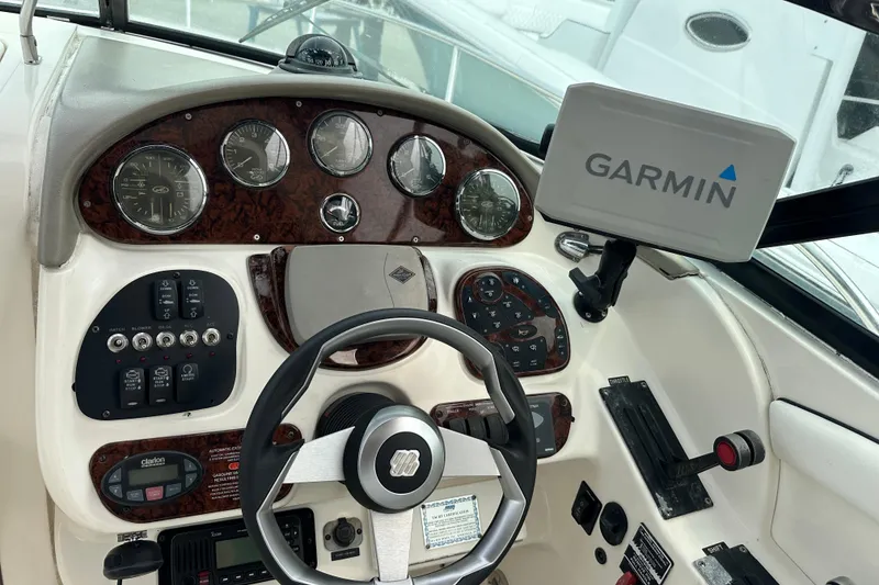 Slide: The Image of Helm of 2005 Sea Ray 290 SLX with Garmin navigation system and classic gauges. - 17