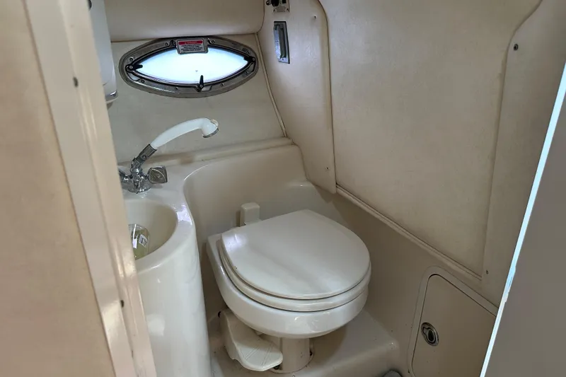 Slide: The Image of 2005 Sea Ray 290 SLX boat bathroom with toilet and sink. - 6
