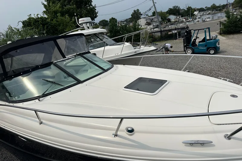 Slide: The Image of 2005 Sea Ray 290 SLX boat docked, featuring sleek design and spacious deck. - 7