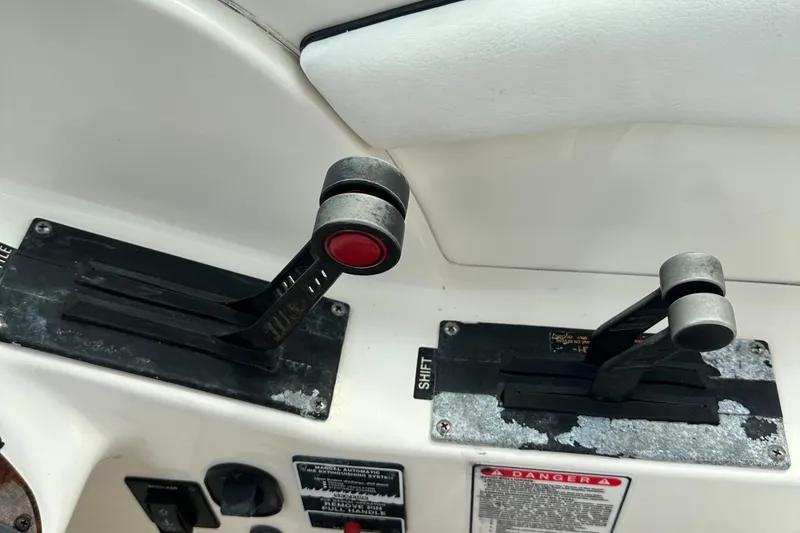 Slide: The Image of Throttle and shift controls on a 2005 Sea Ray 290 SLX boat dashboard. - 9