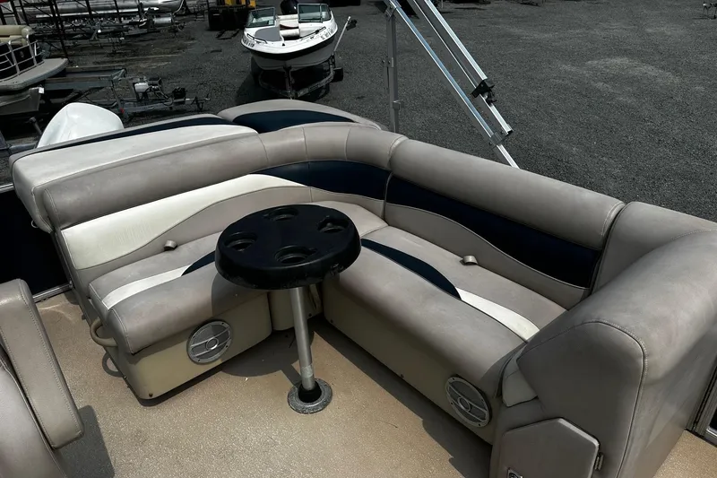 Slide: The Image of 2014 Godfrey Sweetwater 2286 Pontoon interior with cushioned seating and cupholder table. - 10