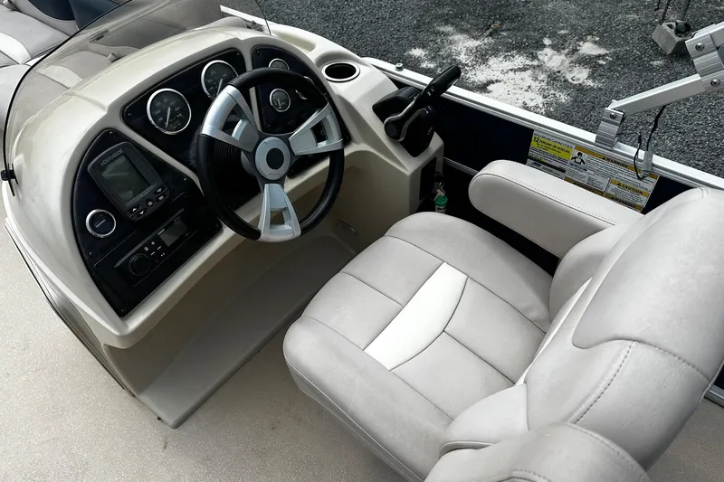 Slide: The Image of 2014 Godfrey Sweetwater 2286 Pontoon boat cockpit with steering wheel and control panel. - 3