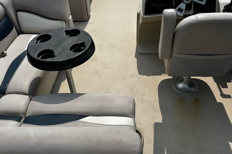 Slide: The Image of Interior of a 2014 Godfrey Sweetwater 2286 Pontoon with seating and cup holder table. - 9