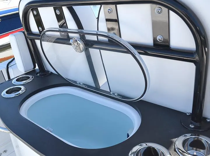 Slide: The Image of 2024 Sea Pro 262 DXL boat with open livewell and cup holders. - 10