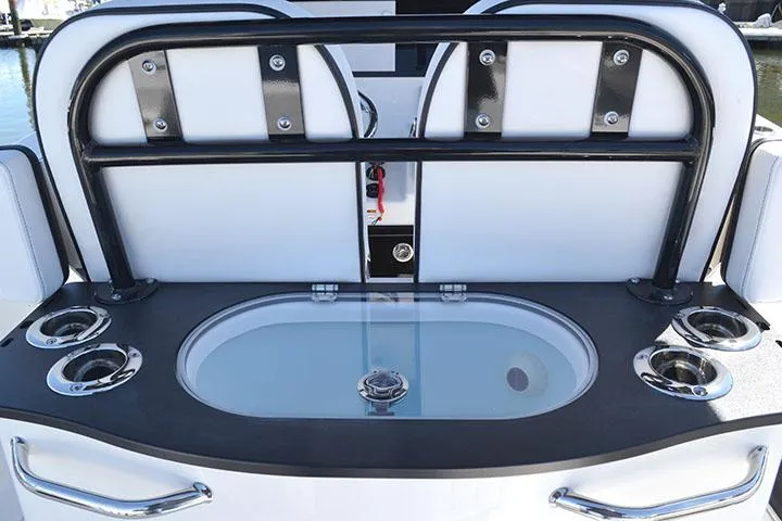 Slide: The Image of 2024 Sea Pro 262 DXL boat interior with livewell and cup holders. - 11