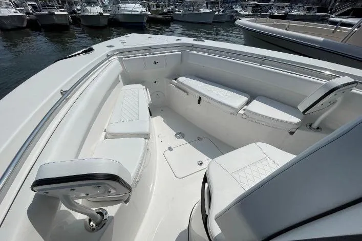 Slide: The Image of 2024 Sea Pro 262 DXL boat interior with white seating and sleek design. - 13