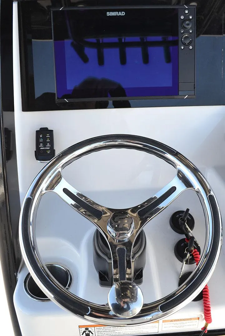 Slide: The Image of 2024 Sea Pro 262 DXL helm with steering wheel and Simrad display. - 5
