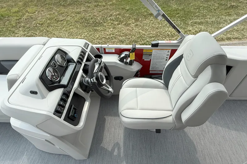 Slide: The Image of 2026 Godfrey Sweetwater 2086 C boat helm with modern controls and comfortable captain's chair. - 11