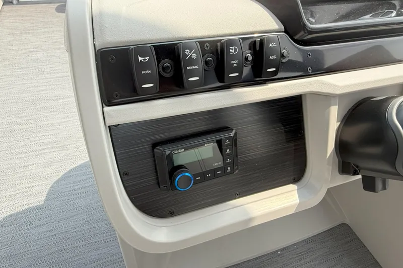 Slide: The Image of Control panel of 2026 Godfrey Sweetwater 2086 C boat with switches and Clarion audio system. - 12