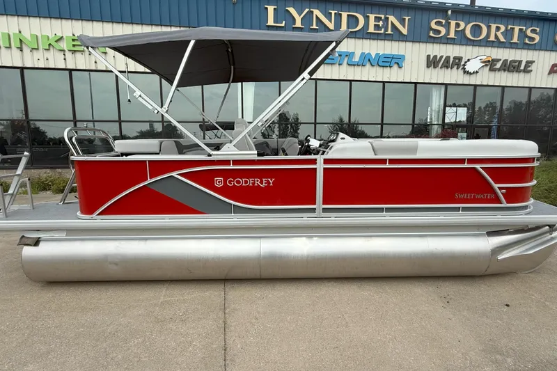 Slide: The Image of 2026 Godfrey Sweetwater 2086 C pontoon boat, red and silver, displayed at Lynden Sports. - 2