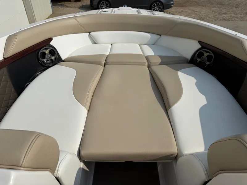 Slide: The Image of 2012 Regal 2700 Bowrider boat interior with beige and white seating. - 10