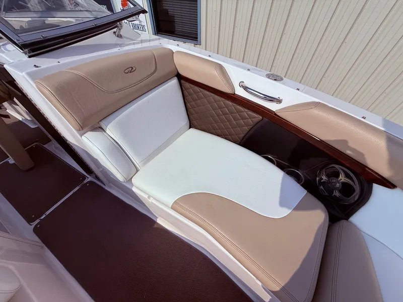 Slide: The Image of 2012 Regal 2700 Bowrider interior with beige and white seating, luxurious design. - 13