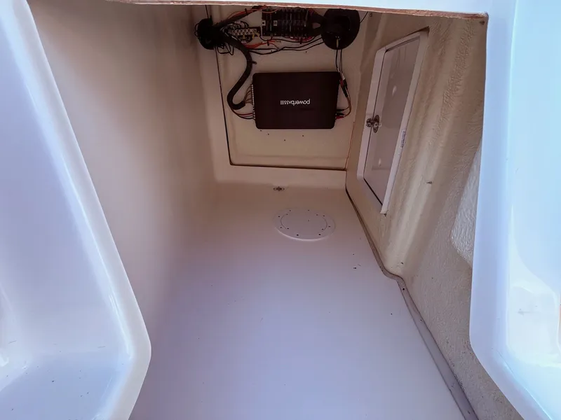 Slide: The Image of 2012 Regal 2700 Bowrider storage compartment with electrical components. - 15