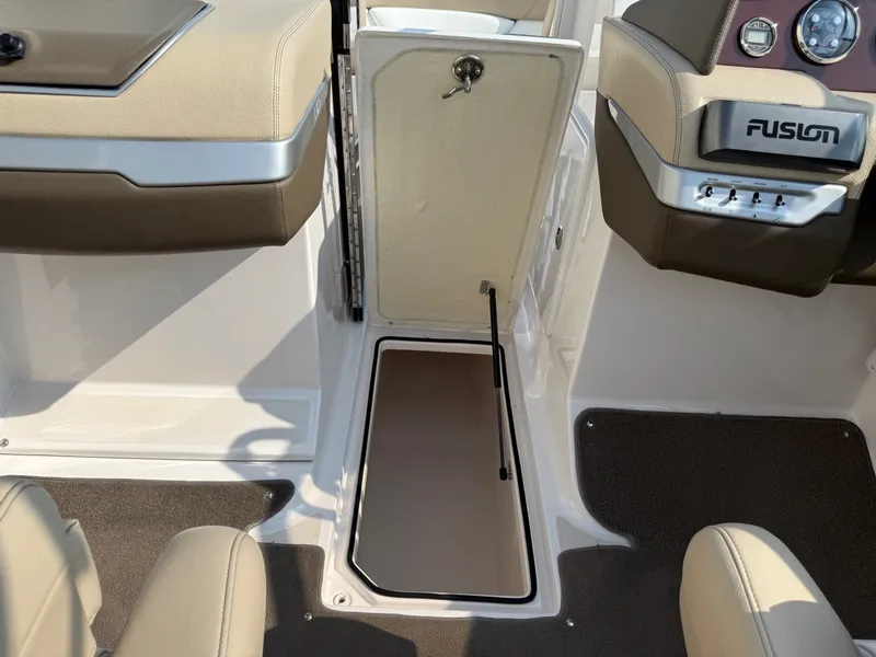 Slide: The Image of 2012 Regal 2700 Bowrider interior with open storage compartment and Fusion audio system. - 18