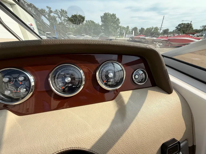 Slide: The Image of Dashboard of a 2012 Regal 2700 Bowrider boat with gauges and controls. - 22