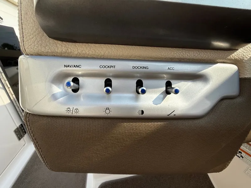 Slide: The Image of Control panel of a 2012 Regal 2700 Bowrider boat with labeled switches. - 26