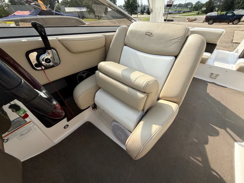Slide: The Image of 2012 Regal 2700 Bowrider interior with beige leather seating and control panel. - 28