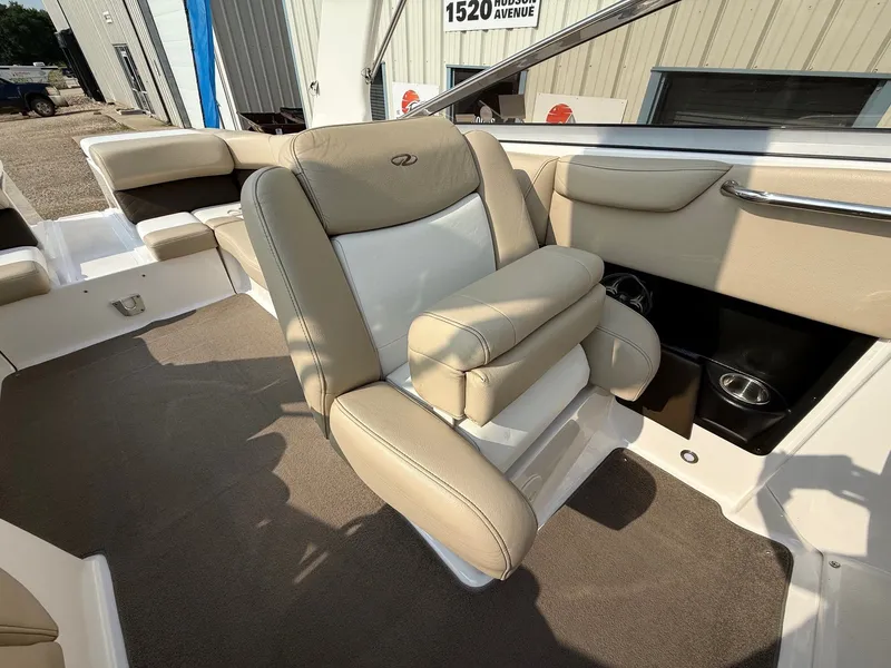 Slide: The Image of 2012 Regal 2700 Bowrider interior with beige seating and carpeted flooring. - 29
