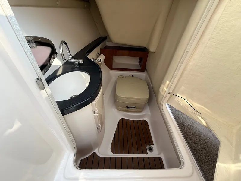 Slide: The Image of 2012 Regal 2700 Bowrider interior with sink and portable toilet. - 31