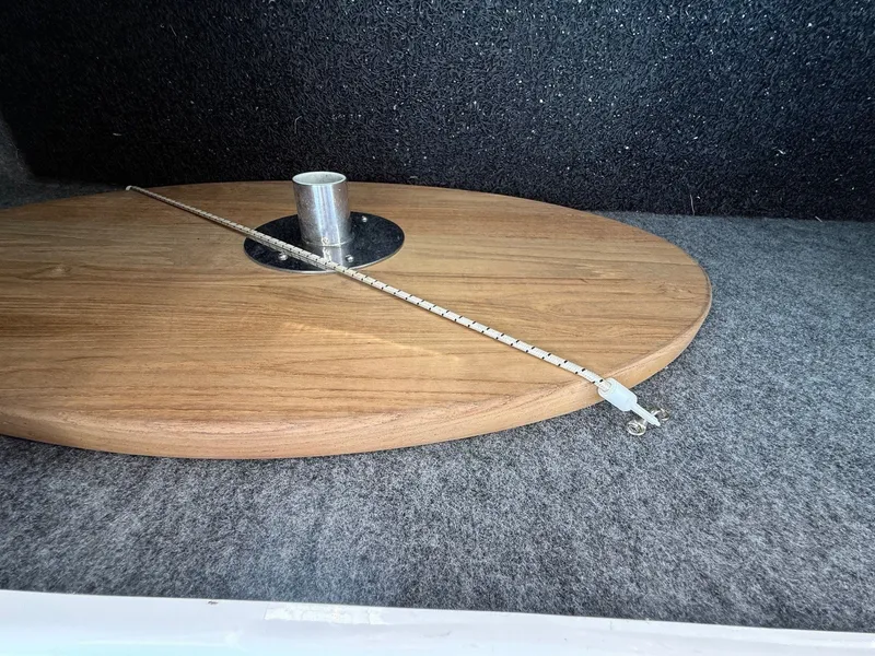 Slide: The Image of Round wooden table with metal pole and chain, inside a 2012 Regal 2700 Bowrider boat. - 32