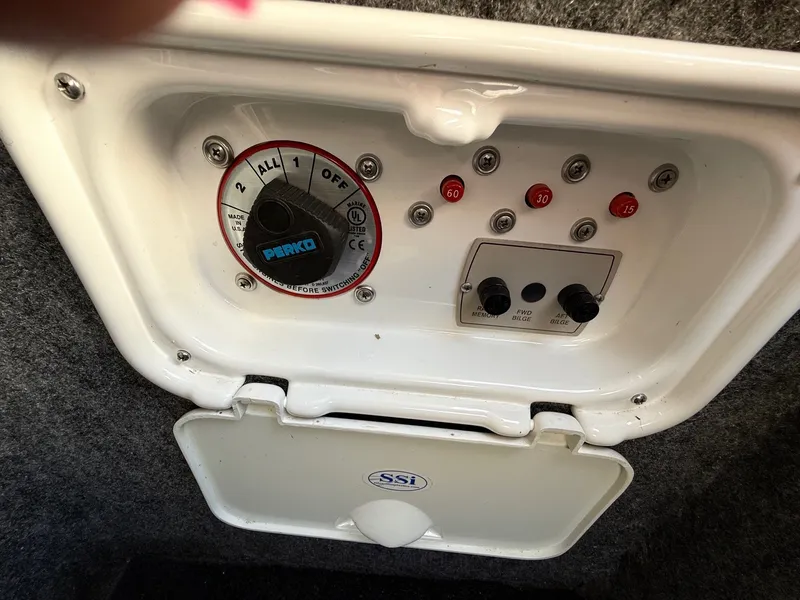 Slide: The Image of Control panel of a 2012 Regal 2700 Bowrider boat with Perko switch and fuse indicators. - 33