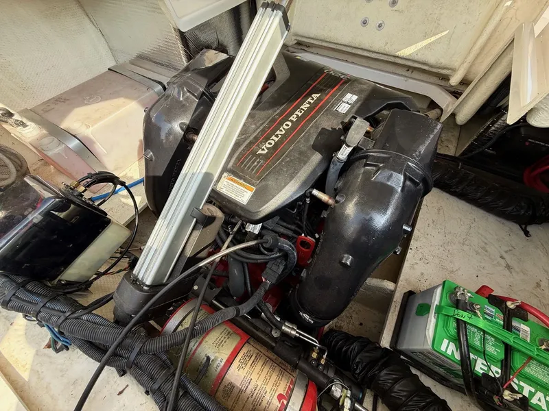Slide: The Image of Volvo Penta engine in 2012 Regal 2700 Bowrider boat, with visible battery and wiring. - 34