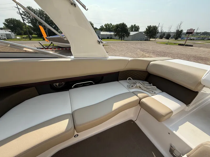 Slide: The Image of 2012 Regal 2700 Bowrider interior with beige seating and coiled rope on deck. - 38