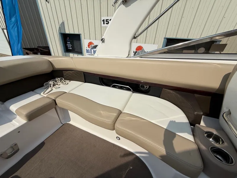 Slide: The Image of Interior of a 2012 Regal 2700 Bowrider boat with beige seating and cup holders. - 39