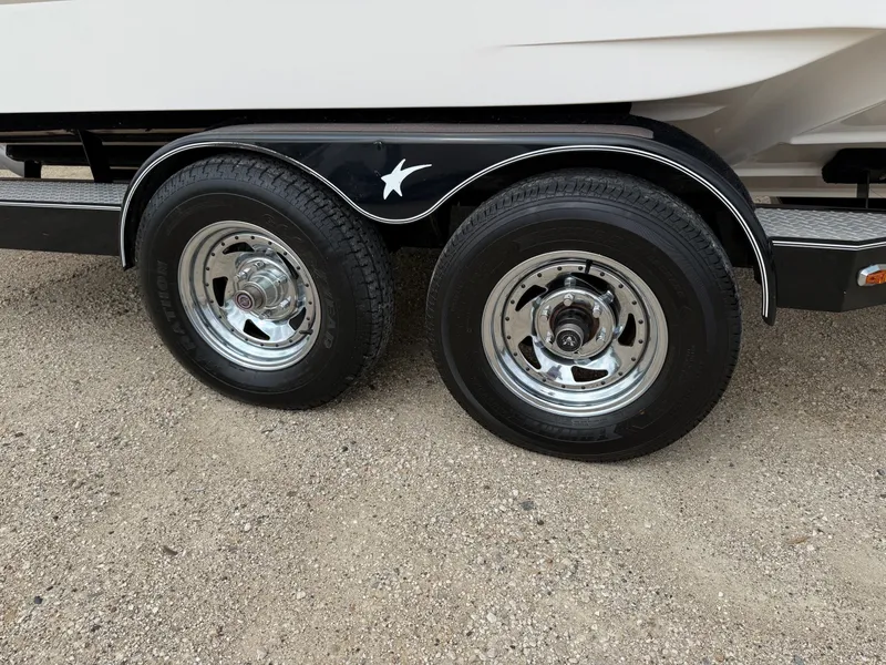 Slide: The Image of Trailer wheels of a 2012 Regal 2700 Bowrider on gravel surface. - 41