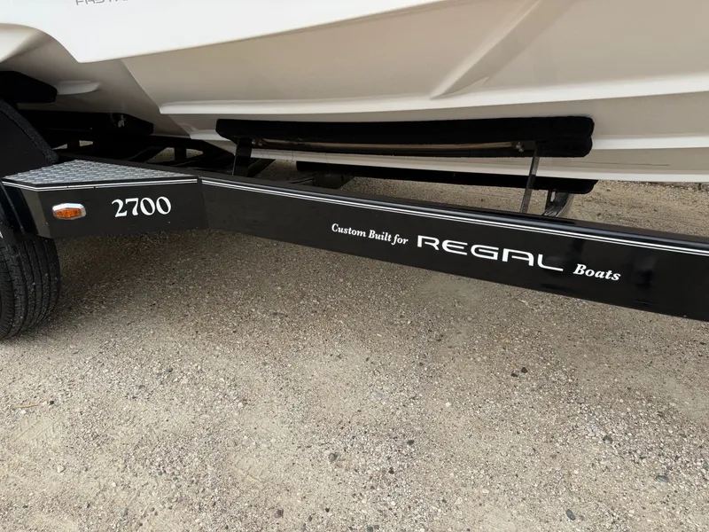 Slide: The Image of Trailer for 2012 Regal 2700 Bowrider boat on gravel surface. - 42