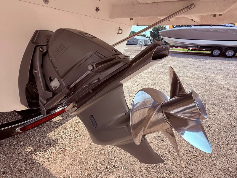 Slide: The Image of Close-up of a 2012 Regal 2700 Bowrider's propeller and outdrive on a gravel surface. - 6