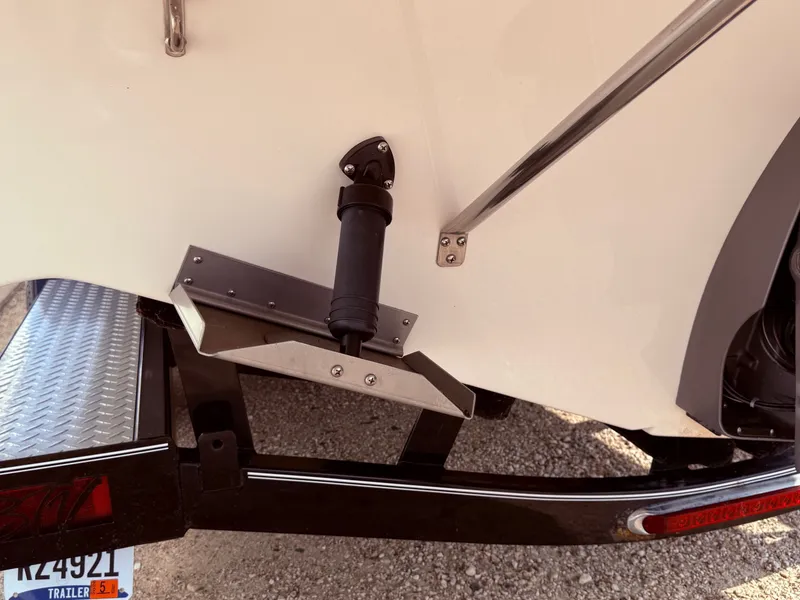 Slide: The Image of 2012 Regal 2700 Bowrider on trailer, showing trim tab and license plate. - 7