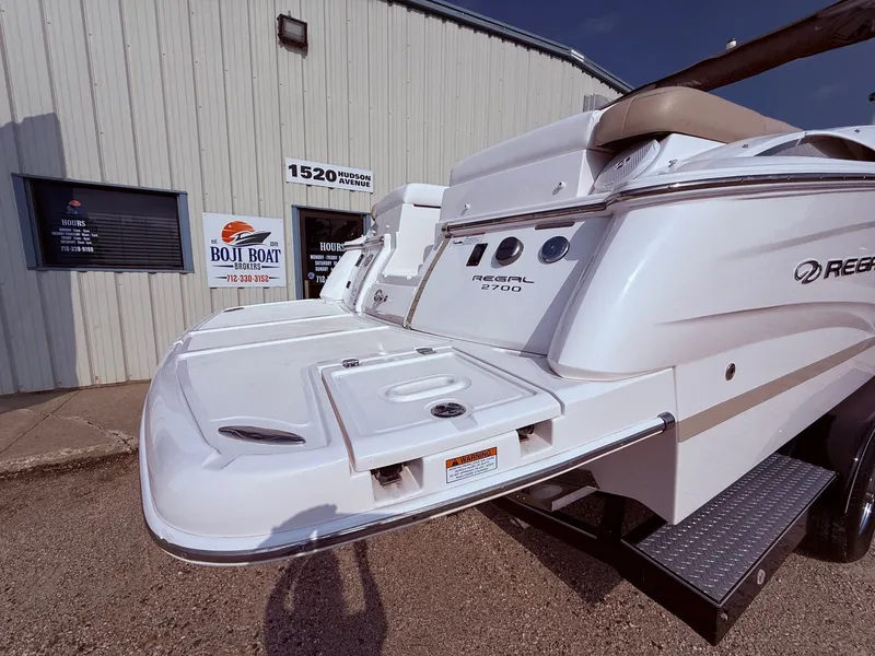 Slide: The Image of 2012 Regal 2700 Bowrider boat displayed outside Boji Boat Brokers building. - 8