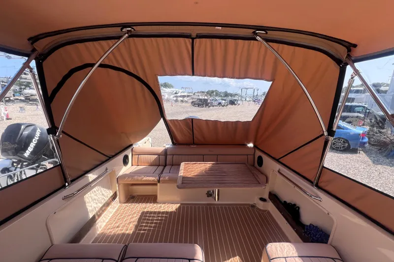 Slide: The Image of Interior of 2018 Rossiter 23 boat with tan canopy and seating area. - 11