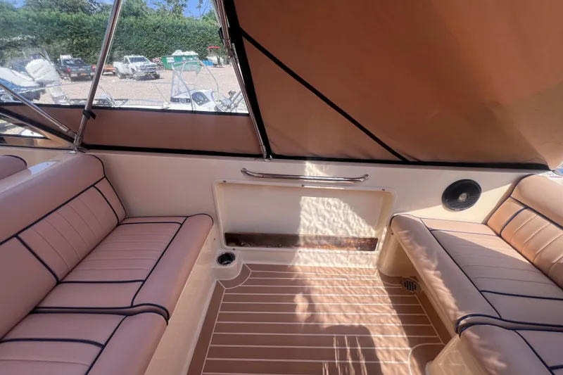 Slide: The Image of Interior of 2018 Rossiter 23 boat with tan seating and canopy. - 13