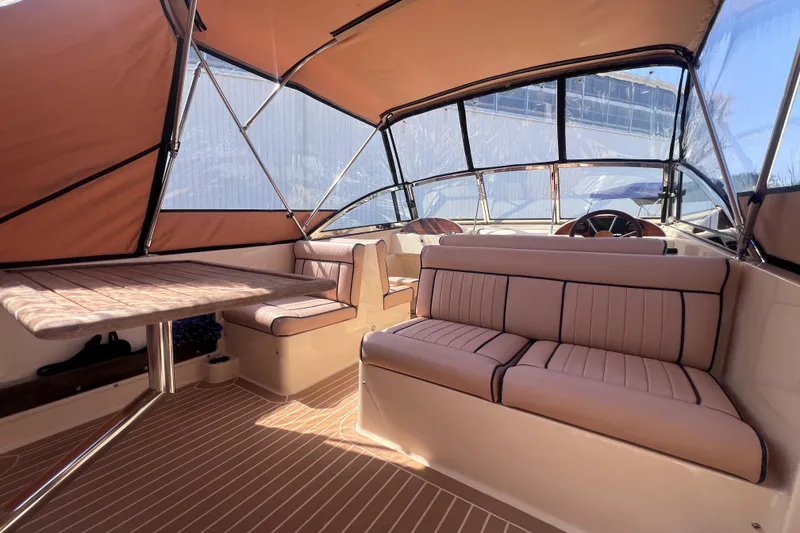 Slide: The Image of Luxurious interior of 2018 Rossiter 23 boat with tan seating and canopy. - 15