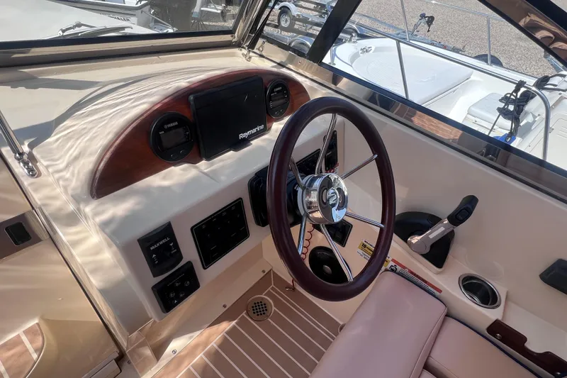 Slide: The Image of Interior view of 2018 Rossiter 23 boat cockpit with steering wheel and controls. - 19