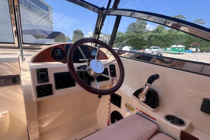 Slide: The Image of Interior view of 2018 Rossiter 23 boat cockpit with steering wheel and controls. - 20