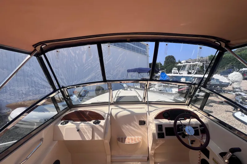 Slide: The Image of Interior view of a 2018 Rossiter 23 boat cockpit with steering wheel and dashboard. - 27